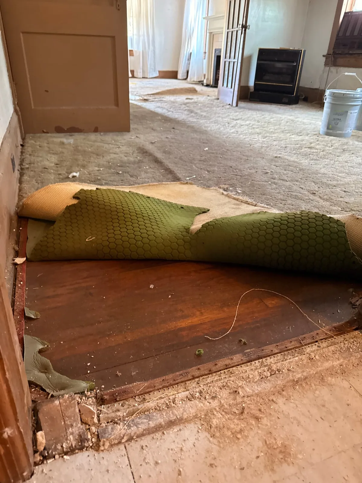 D Nixon Ave original hardwood flooring exposed beneath carpet before restoration