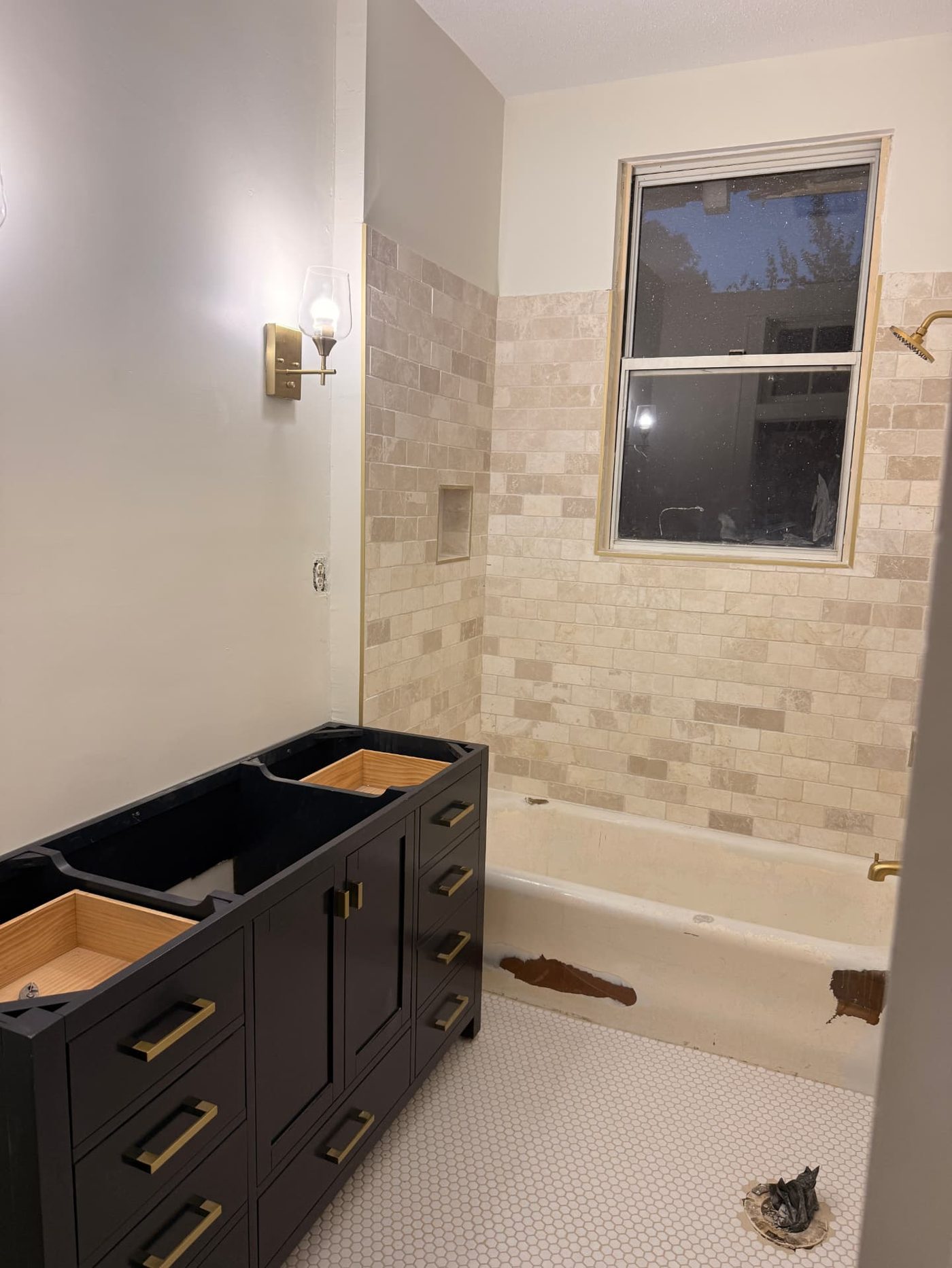 Lawrence project — finished bathroom tile with new vanity and brass fixtures in place