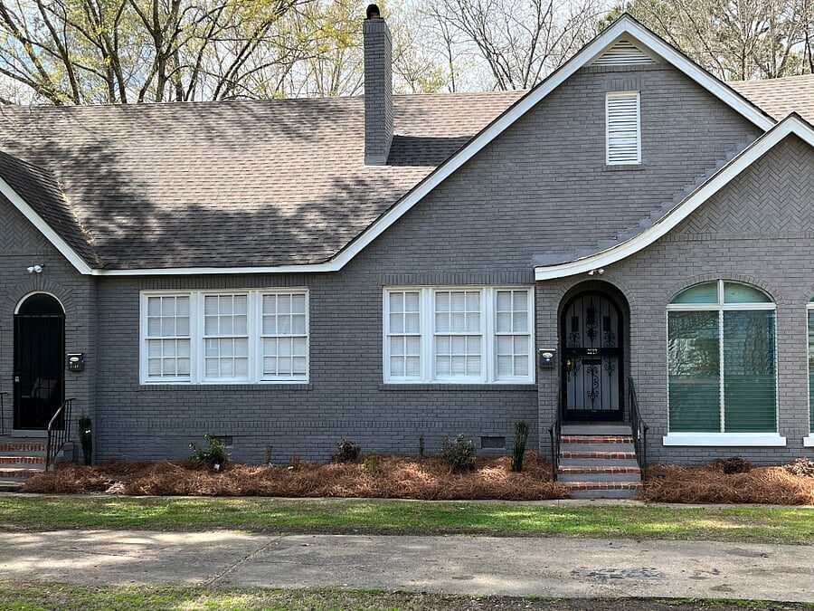 Blue Magnolia painted-brick exterior and arched front entry